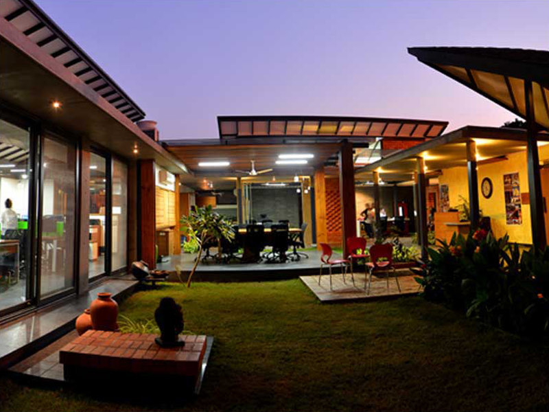 The AA&E studio — the studio courtyard at dusk, lit from within