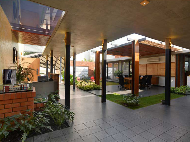 The AA&E studio — the open studio under its pitched roof, planting between the bays
